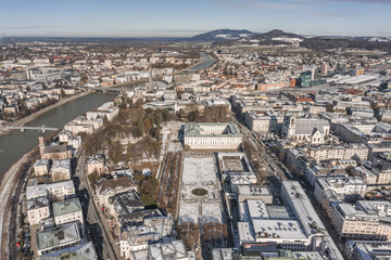Fototapeta premium Aerial drone view of snowy Mirabelle Palace in Salzburg downtown