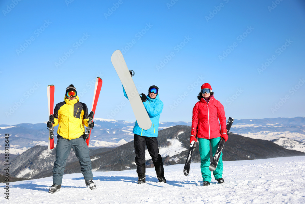 Wall mural friends with equipment at ski resort. winter vacation