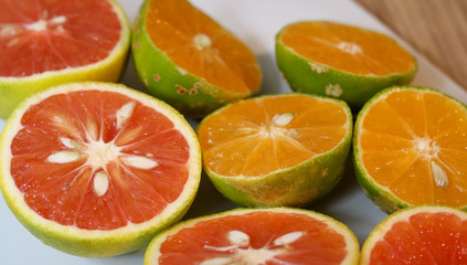 Fototapeta na wymiar Beautiful lemons and grapefruits cut in half on a cutting board.
