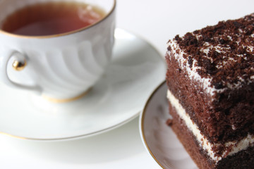 Homemade chocolate brownies with cup of tea on white background, selective focus