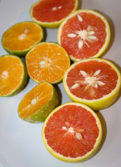 Naklejka na ściany i meble Beautiful lemons and grapefruits cut in half on a cutting board.
