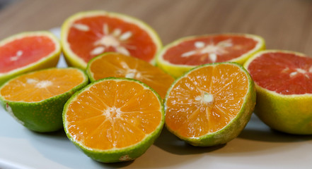 Fototapeta na wymiar Beautiful lemons and grapefruits cut in half on a cutting board.