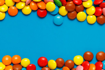  sweet colored candy close up on blue back ground with copy space for text