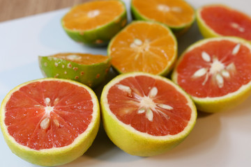 Beautiful lemons and grapefruits cut in half on a cutting board.