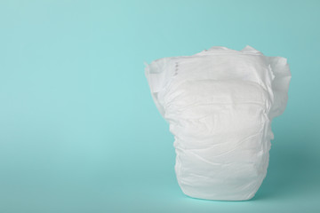 Baby diaper on light blue background. Space for text