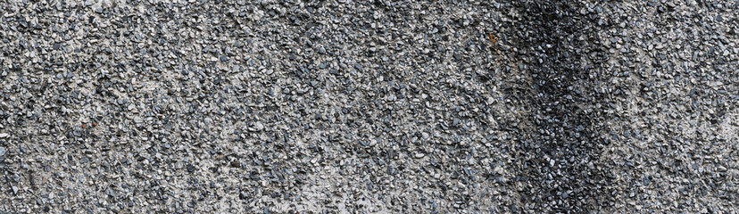Panoramic texture of old gray concrete wall. Old rough plastered wall.