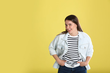 Portrait of young woman on yellow background. Space for text