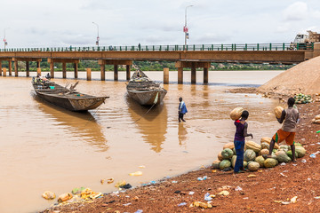 Wooden boats on Niger River muddy water 