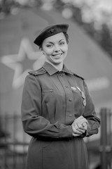 Retro style black and white photography. A young female pilot in uniform of Soviet Army pilots...