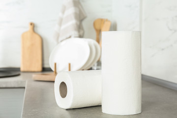 Rolls of paper towels on light grey table in kitchen