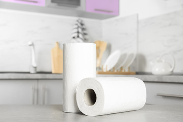 Rolls of paper towels on light grey table in kitchen