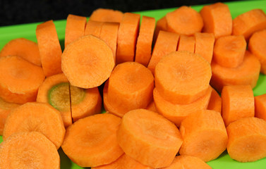 Beautiful carrots cut into slices on top of a cutting board.
