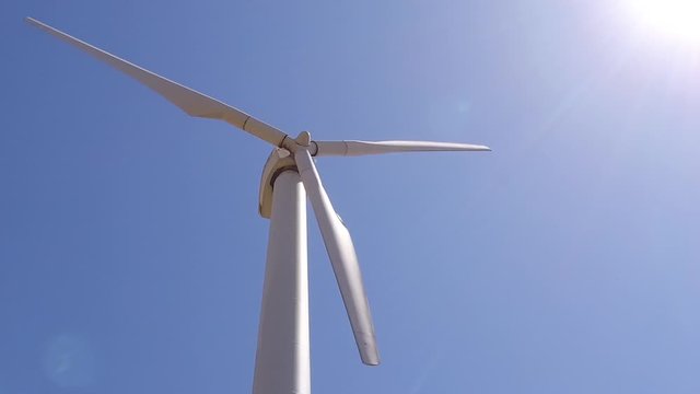 wheat field with eolic turbines wind renewable energy farm slow motion