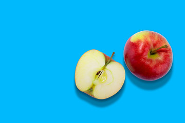 Red apples isolated on a blue background.