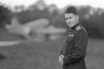Retro style black and white photography. A young adult male pilot in the Military uniform of pilots...