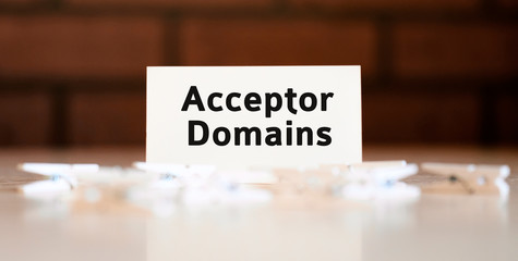 Acceptor Domains - text concept on a brick background and lie white pins