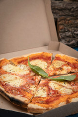 Food delivery. Margarita pizza on wooden board 