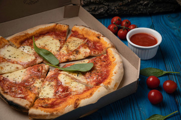 Food delivery. Margarita pizza on wooden board 