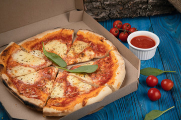 Food delivery. Margarita pizza on wooden board 