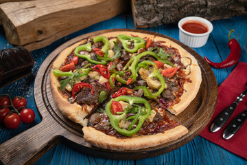 Italian pizza with meat on blue background