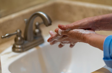 Ladies hands with soap in hand washer