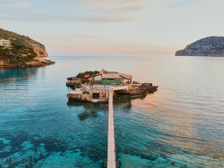 Top view of the golden sand of the beach Camp de Mar and turquoise water of the Mediterranean...