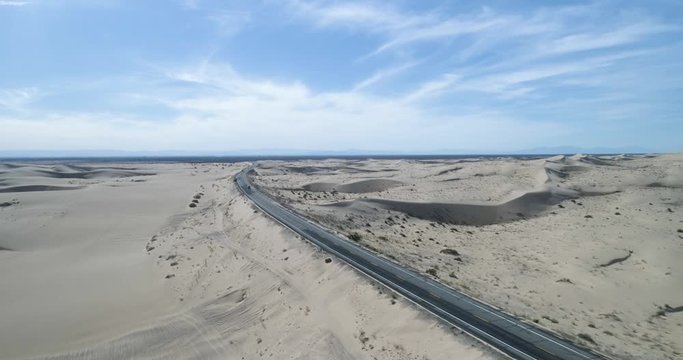 Highway going through sand dunes at North Algodones dunes, California