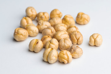Roasted yellow chickpeas on a white background