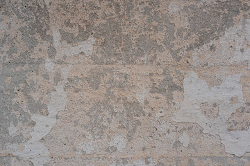 Texture of an old concrete wall with peeling white paint