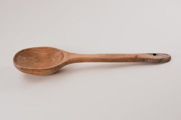 Old wooden spoon on a white background