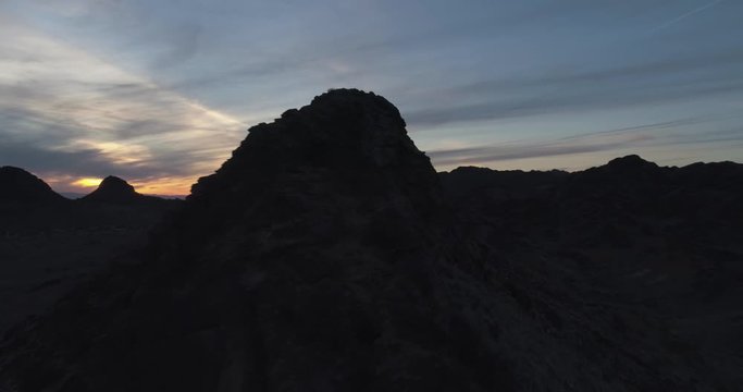 Close pass by rocky mountains illuminated by beautiful sunset