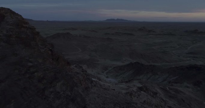 Fly through rocks looking out over martian desolate landscape