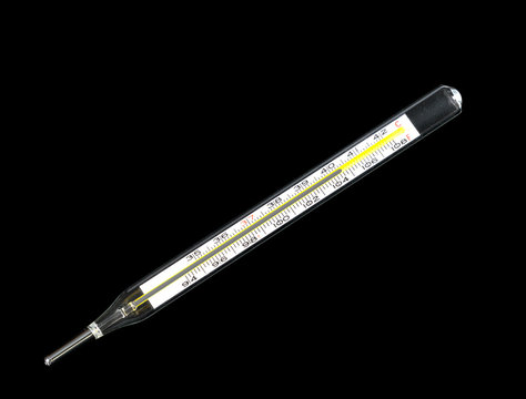 Close up of a glass mercury thermometer showing a feverish temperature of 104 degrees
