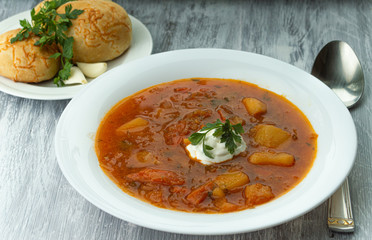 Ukrainian borscht with donuts and sour cream.