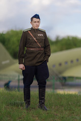 A young adult male pilot in the uniform of pilots of the Soviet Army of the World War II period....