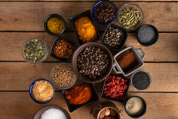 Bowls of spices placed in the center of a wooden table