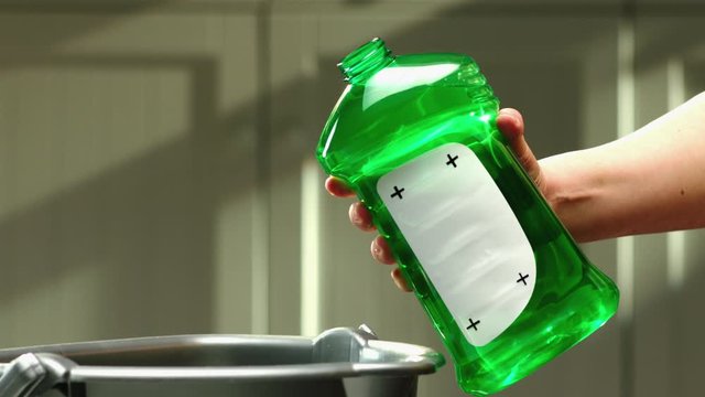 Cleaning agent is poured into bucket from green bottle with replaceable label place holder