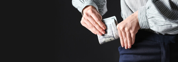Man putting bribe into pocket on black background, closeup with space for text. Banner design