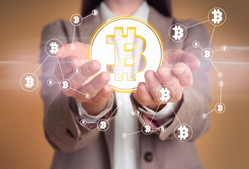 Fintech concept. Woman demonstrating scheme with bitcoin symbols