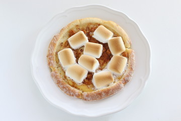 Marshmallow and sugar pizza on dish for sweet food