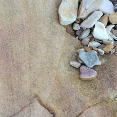 Fototapeta na wymiar Close up of small rounded rocks on boulder background