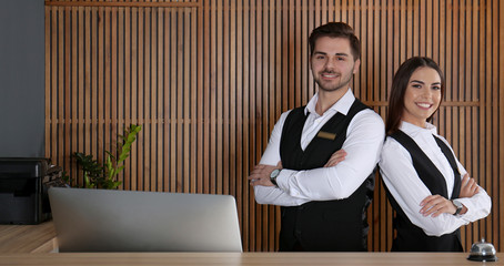 Smiling receptionists at desk in modern lobby. Banner design