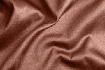 Obraz premium Textured rose gold fabric as background, closeup view