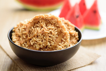 Local Thai snack, Deep fried sweet crispy rice mixed with watermelon juice and cane sugar drizzle (Khao Tan Nam Tangmo)
