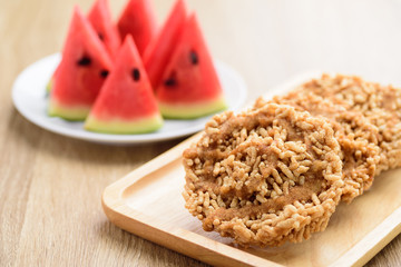 Local Thai snack, Deep fried sweet crispy rice mixed with watermelon juice and cane sugar drizzle (Khao Tan Nam Tangmo)