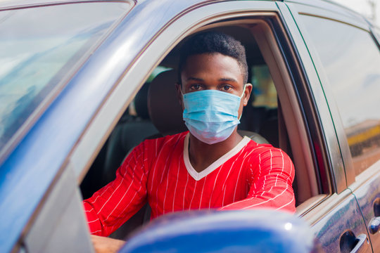 Young Handsome African Taxi Driver Wearing Face Mask Preventing, Prevent, Prevented Himself From The Outbreak In The Society