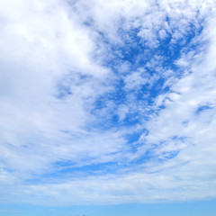 The blue sky and motion white fluffy clouds