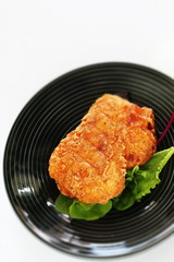 Fried chicken on white dish with copy space