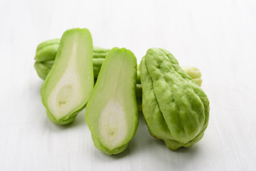 Chayote squash or Mirlition squash on white table, Organic vegetable, Edible plant fruit
