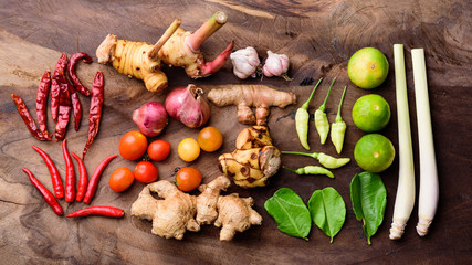 Thai food ingredients, spices and herbs for cooking on wooden background, organic vegetables